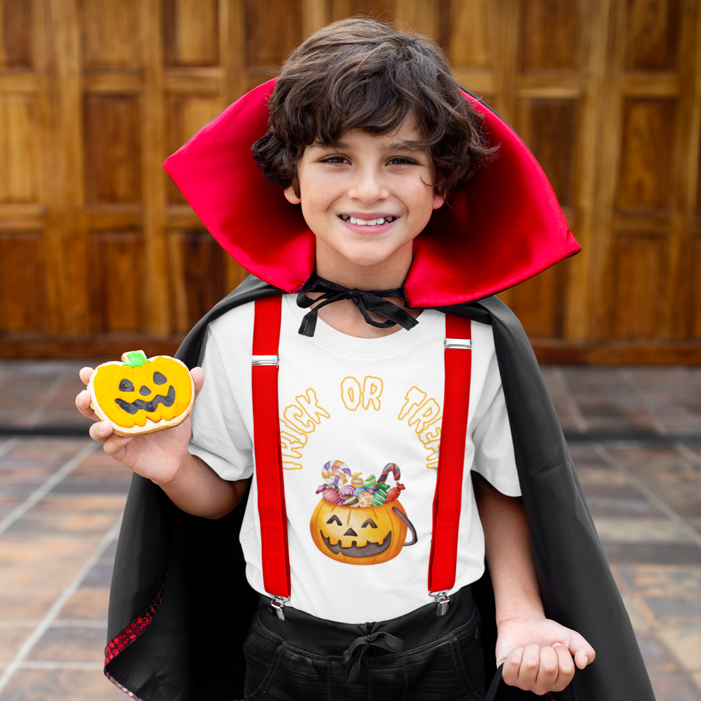 Kids Halloween T-shirt - Trick or Treat pumpkin with sweets in orange and black.